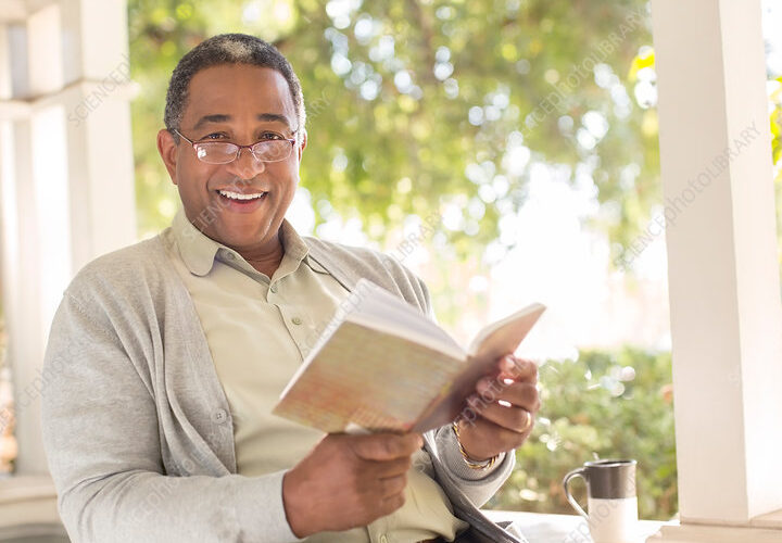 a person reading a book with a smile